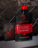 Cheribundi Pure tart cherry juice concentrate against a metal fence, a natural cherry juice concentrate for gout.