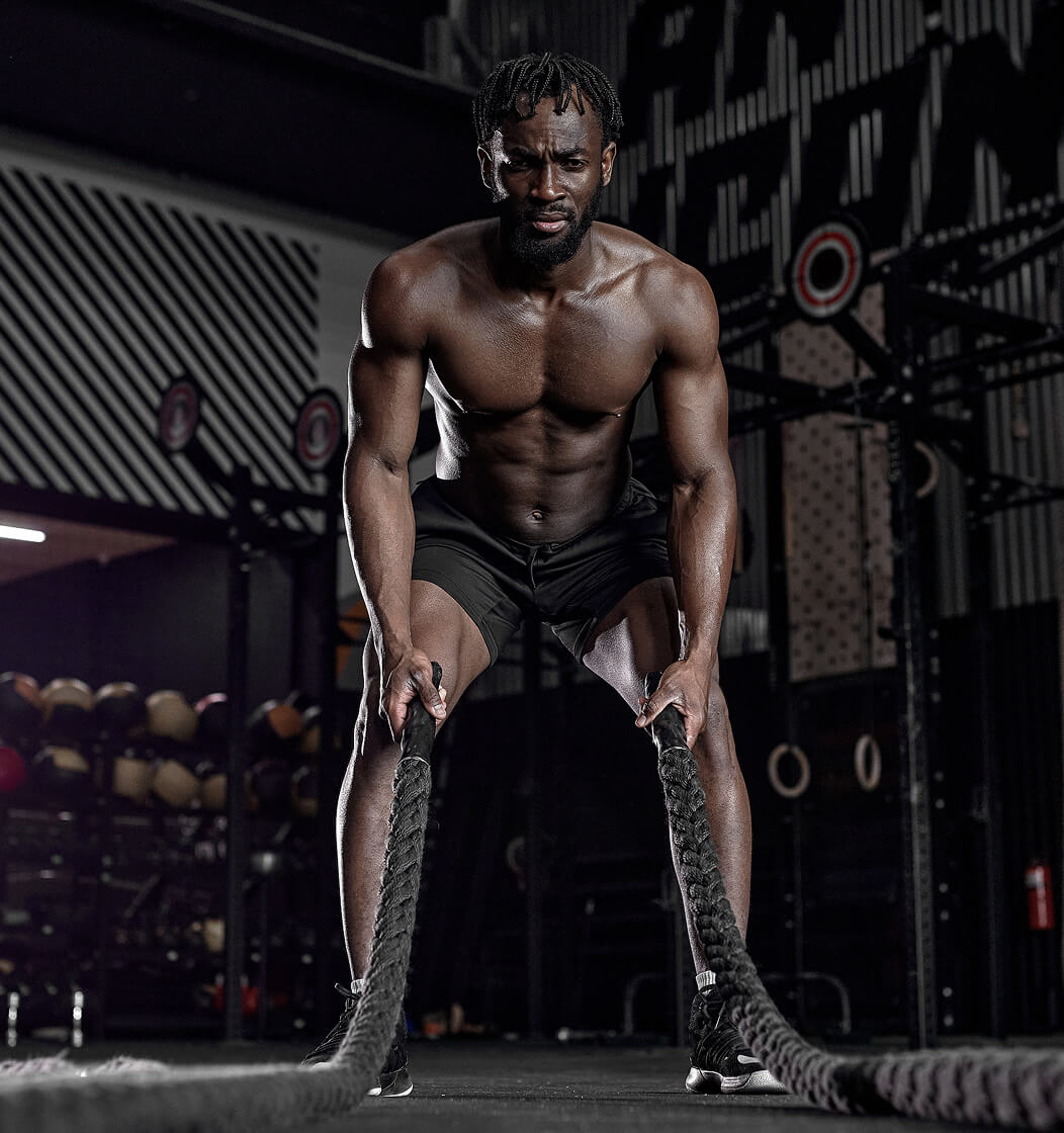 Athlete training with battle ropes